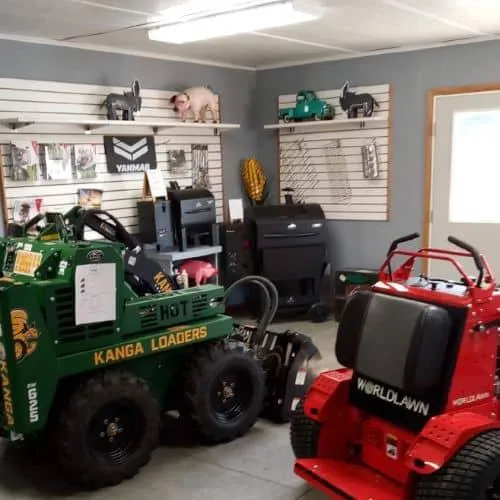 ZDE showroom displaying Kanga loaders and WorldLawn mowers with Yanmar brochures at Illinois dealership
