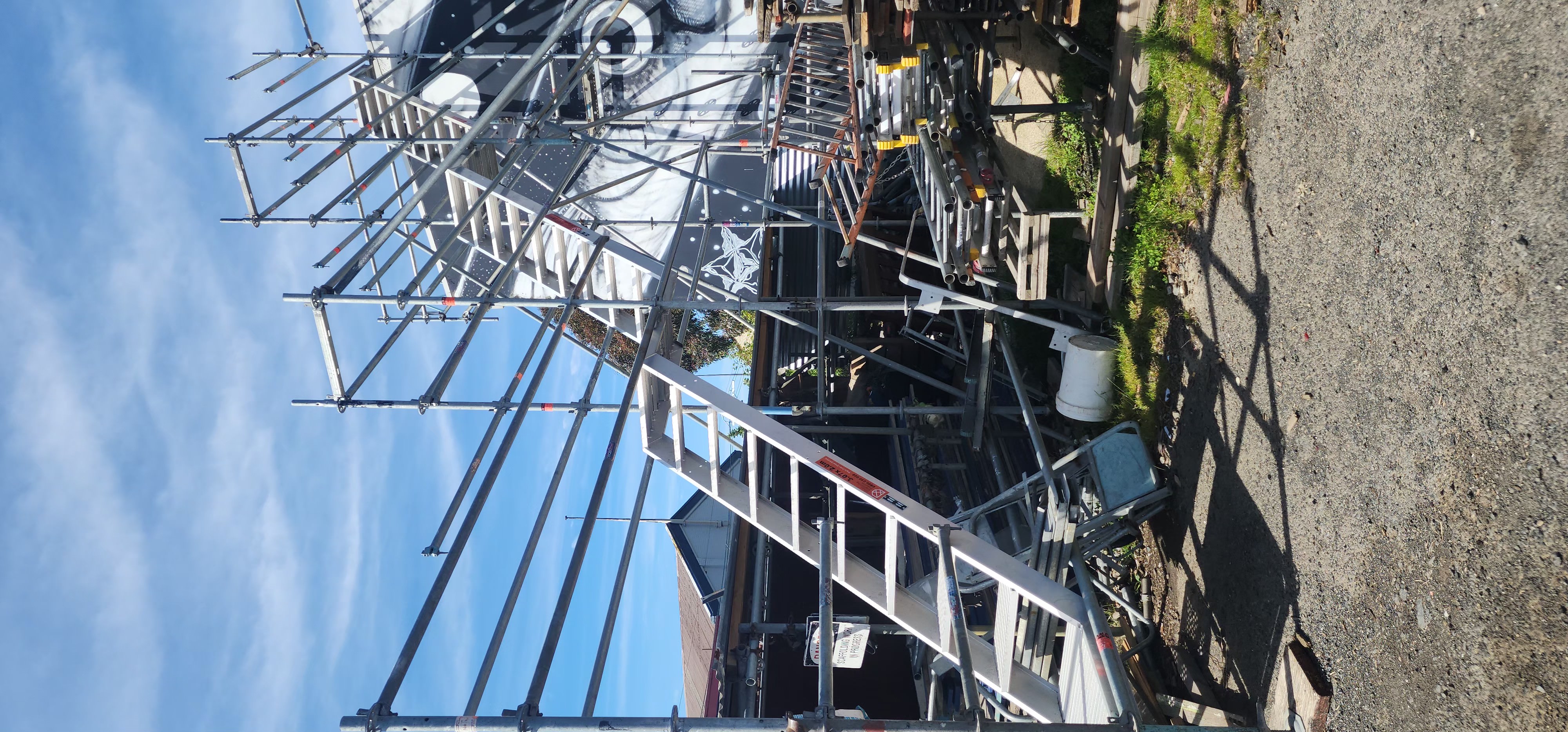 Dark grey longrun roofing replacement in progress with scaffolding in Otago