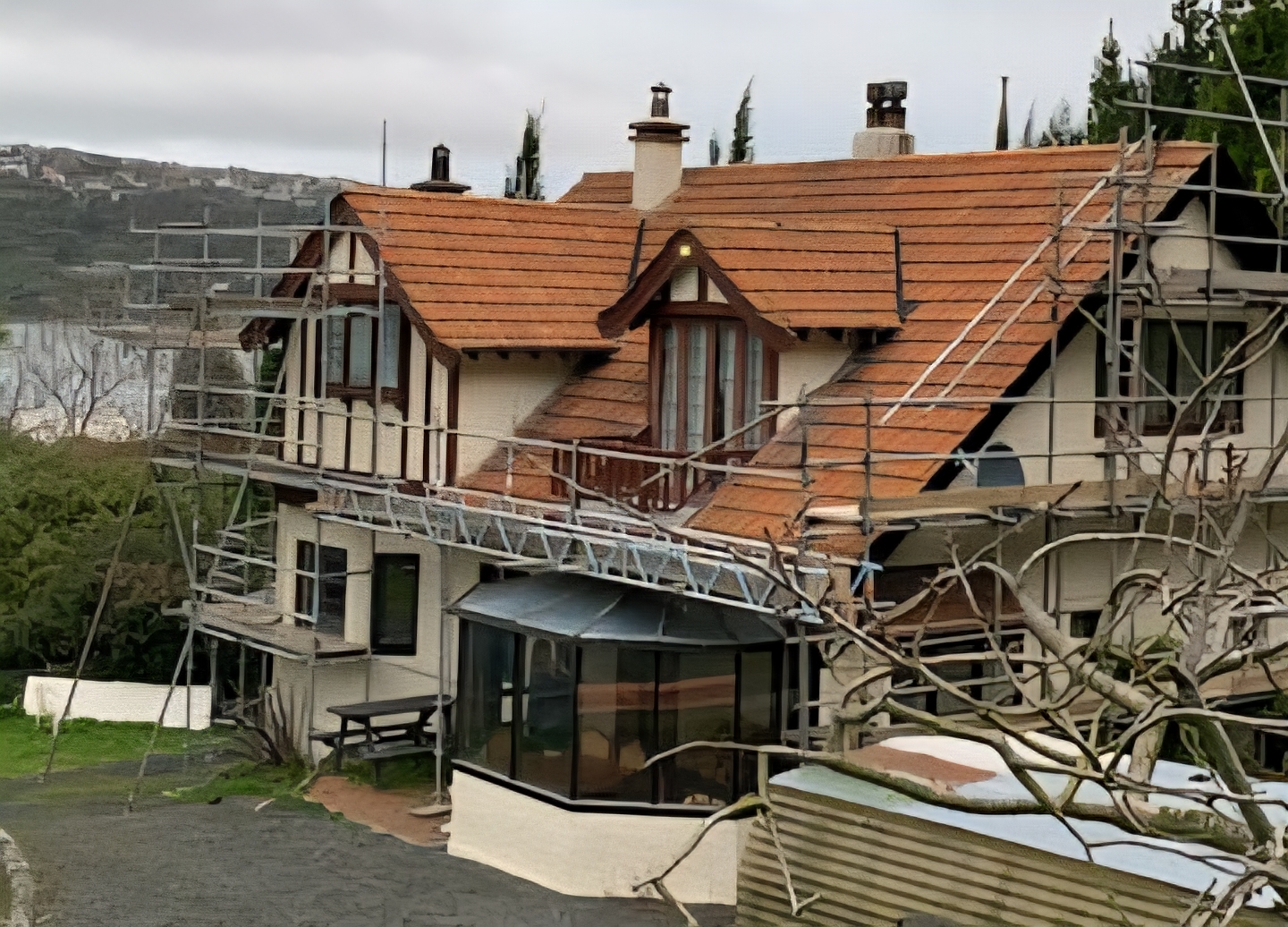 Dark grey longrun roofing replacement in progress with scaffolding in Otago
