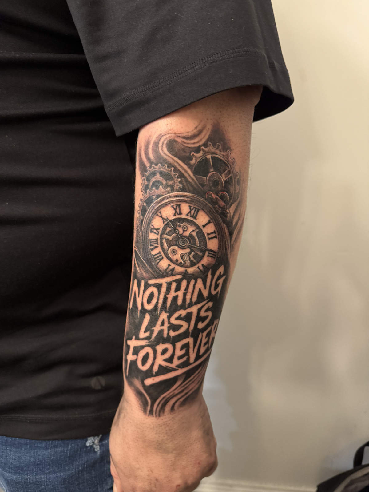 person in blue denim shorts and white nike sneakers standing on gray concrete floor