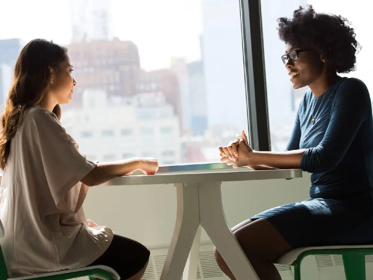 mother and therapist sitting at a table discussing maternal mental health and postpartum transition