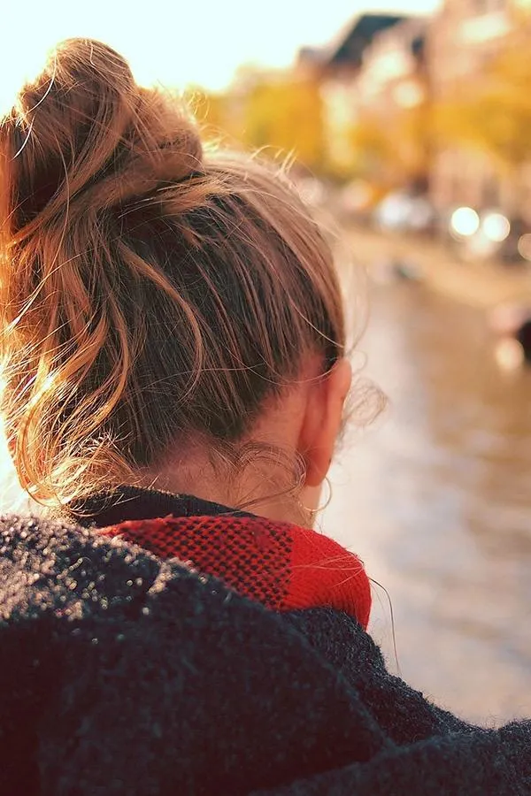A holistic consultant analyzing a hair mineral analysis chart on a digital tablet, with a healthy professional client beside her, both smiling in a bright, plant-filled consultation room. 3:2 aspect ratio.