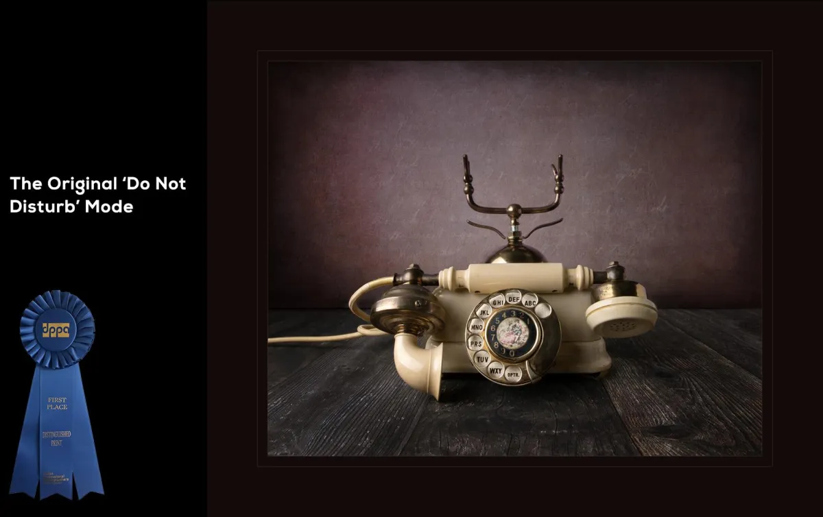 "The Original 'Do Not Disturb' Mode" - Dallas Professional Photographer's Association: Illustrative - Commercial, First Place. Fine Art Still Life featuring an old style phone with the handset off the hook.