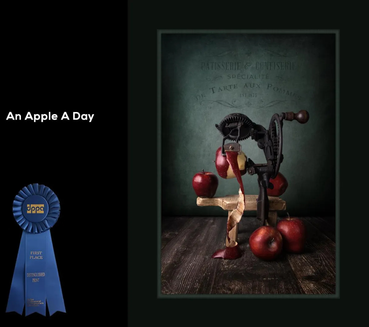 "An Apple A Day" - Dallas Professional Photographer's Association: Illustrative - Landscape/Nature, First Place. Fine Art Still Life of an antique cast iron apple peeler with 5 apples on a wooden tabletop with a green antiqued background. 