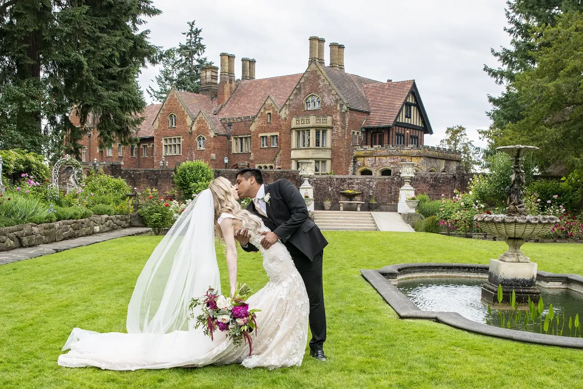 Groom dips bride in the garden at the Thornewood Castle