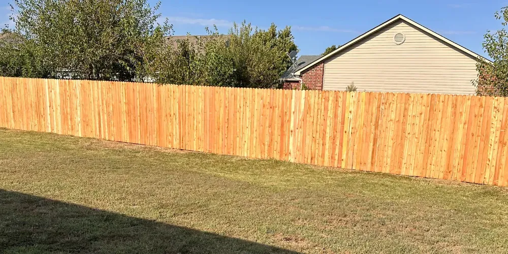 Fence staining service in Oklahoma City protecting wooden privacy fence