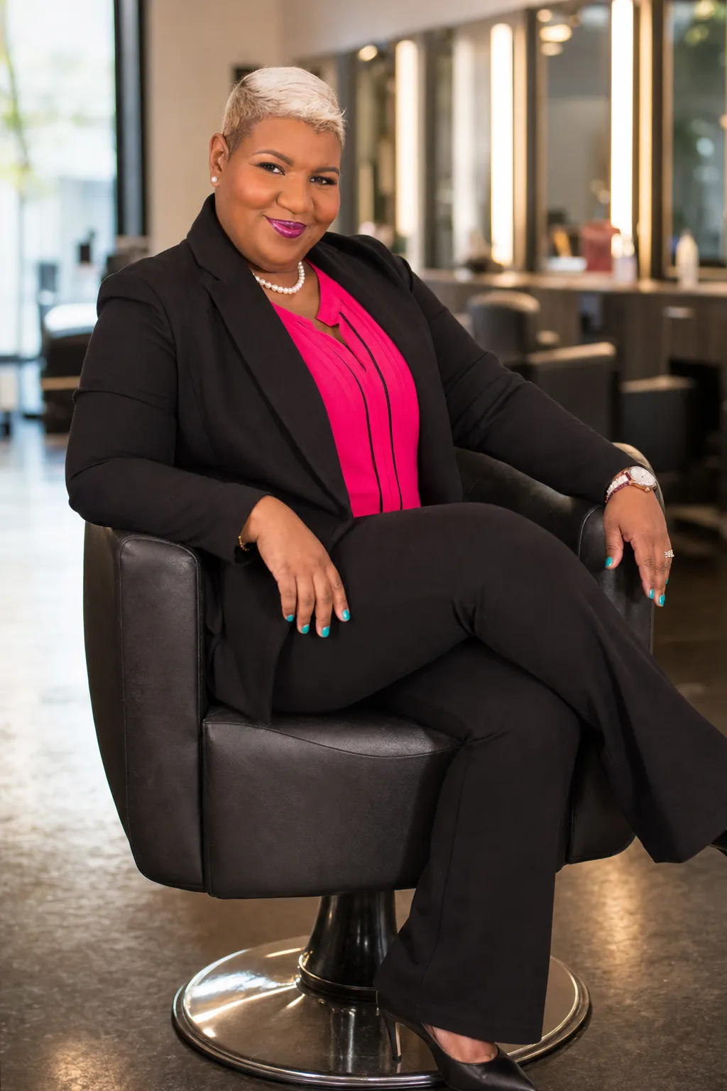 Confident woman with healthy natural hair receiving a professional salon consultation