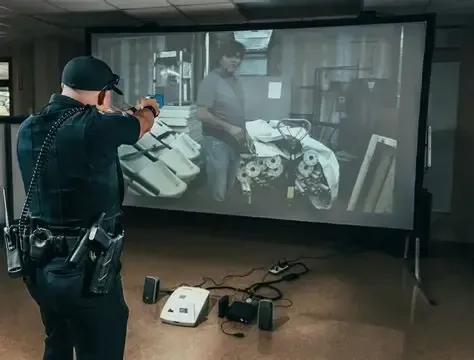 Police officer aims a training taser at the simulator screen
