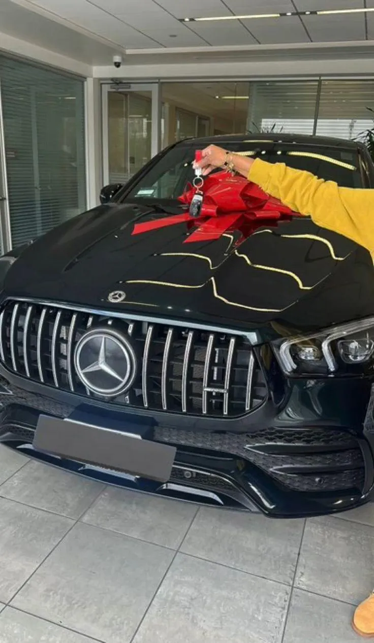 person holding pencil and stick note beside table