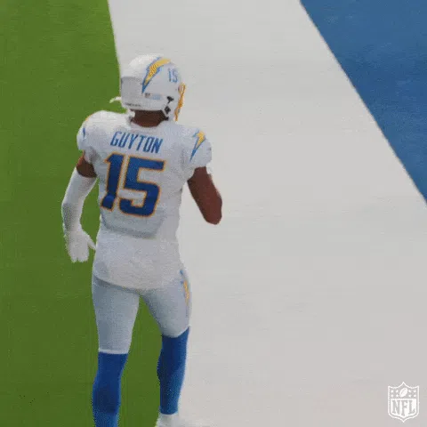 LA Chargers players celebrating with a chest bump