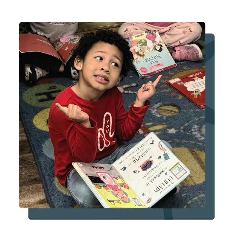 Child learning in preschool with book
