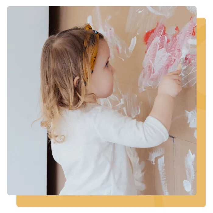 child painting in childcare