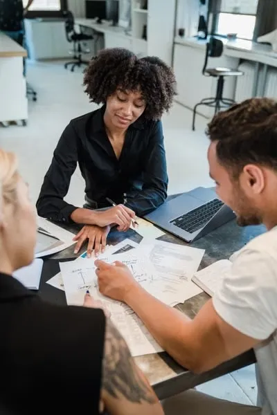 A professional business coach meeting one-on-one with a client, discussing strategies, goals, and actionable plans to support business growth and long-term success.
