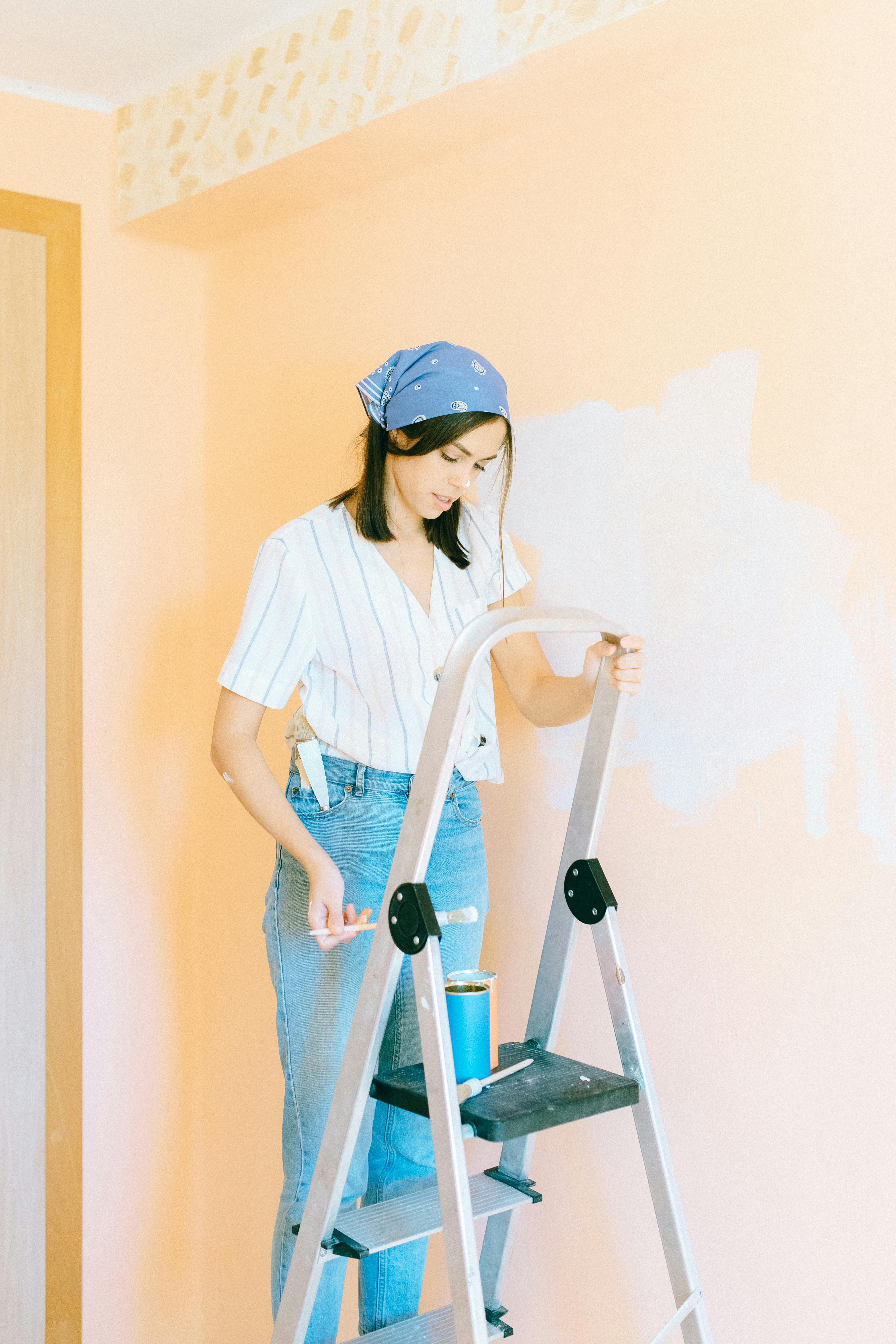 a woman uses a metal ladder to climb up