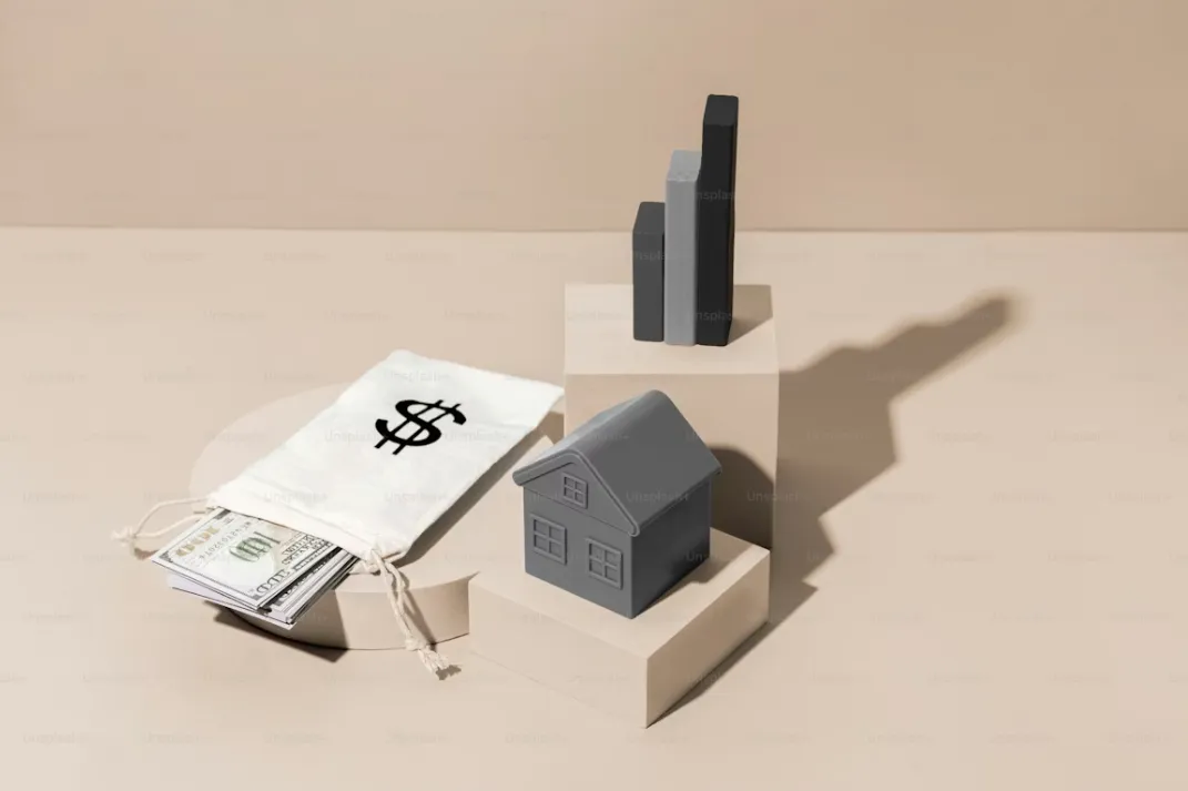 Woman typing on laptop at wooden table with breakfast.