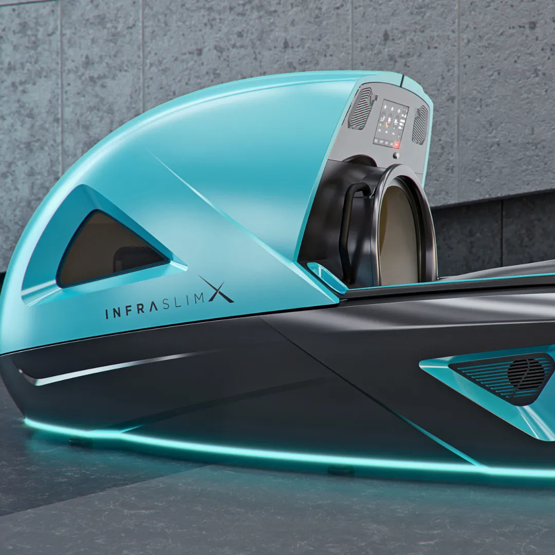 InfraslimX machine in turquoise and black with LED lights. The high-tech design features a futuristic shape, and the user control panel is visible on the machine’s front.