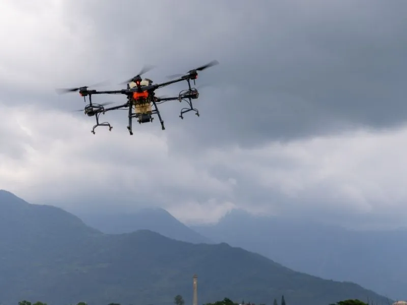 Professional drone carrying mapping equipment over mountainous terrain for aerial data collection.