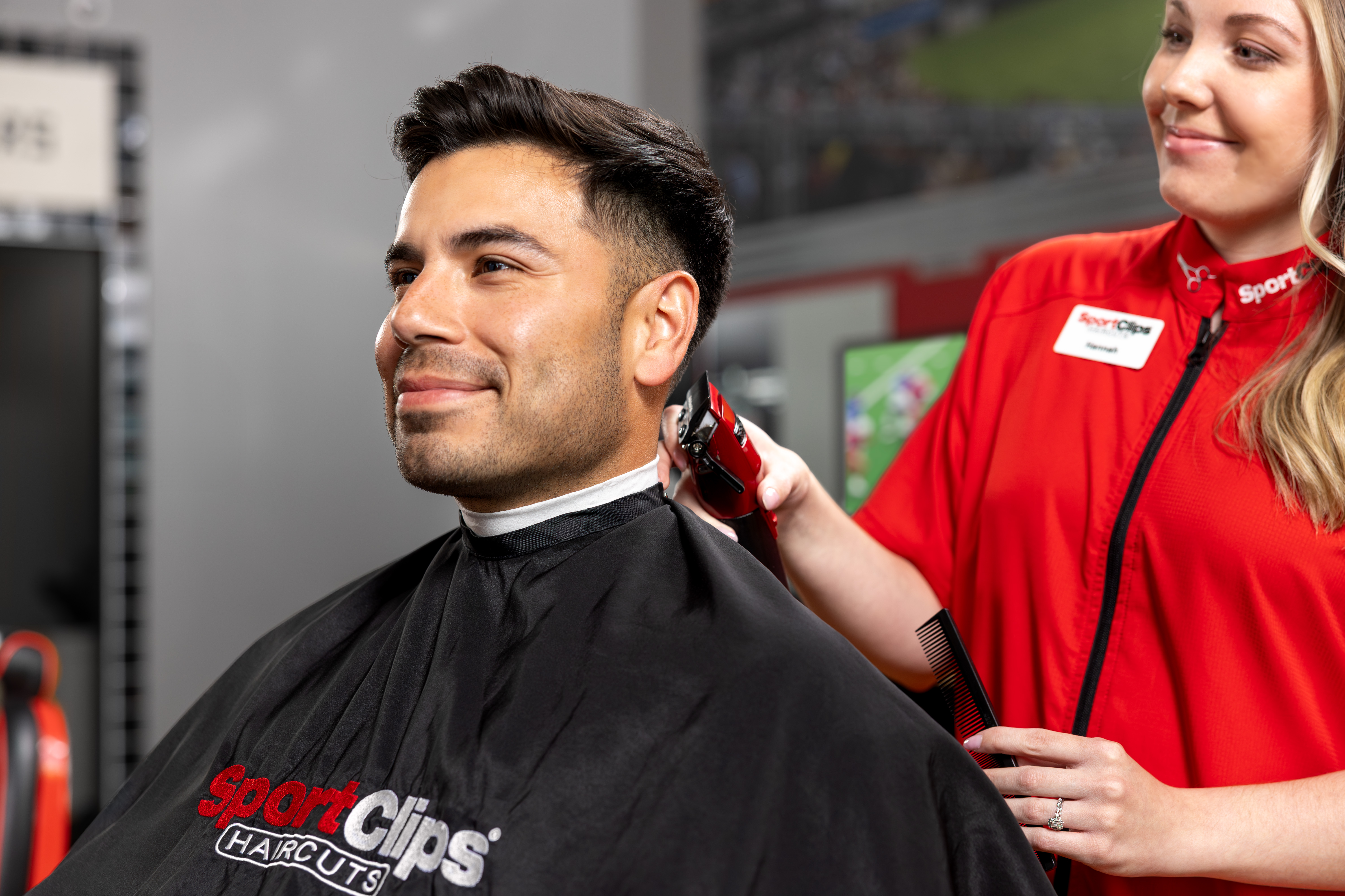 Man stretching legs on outdoor exercise equipment.