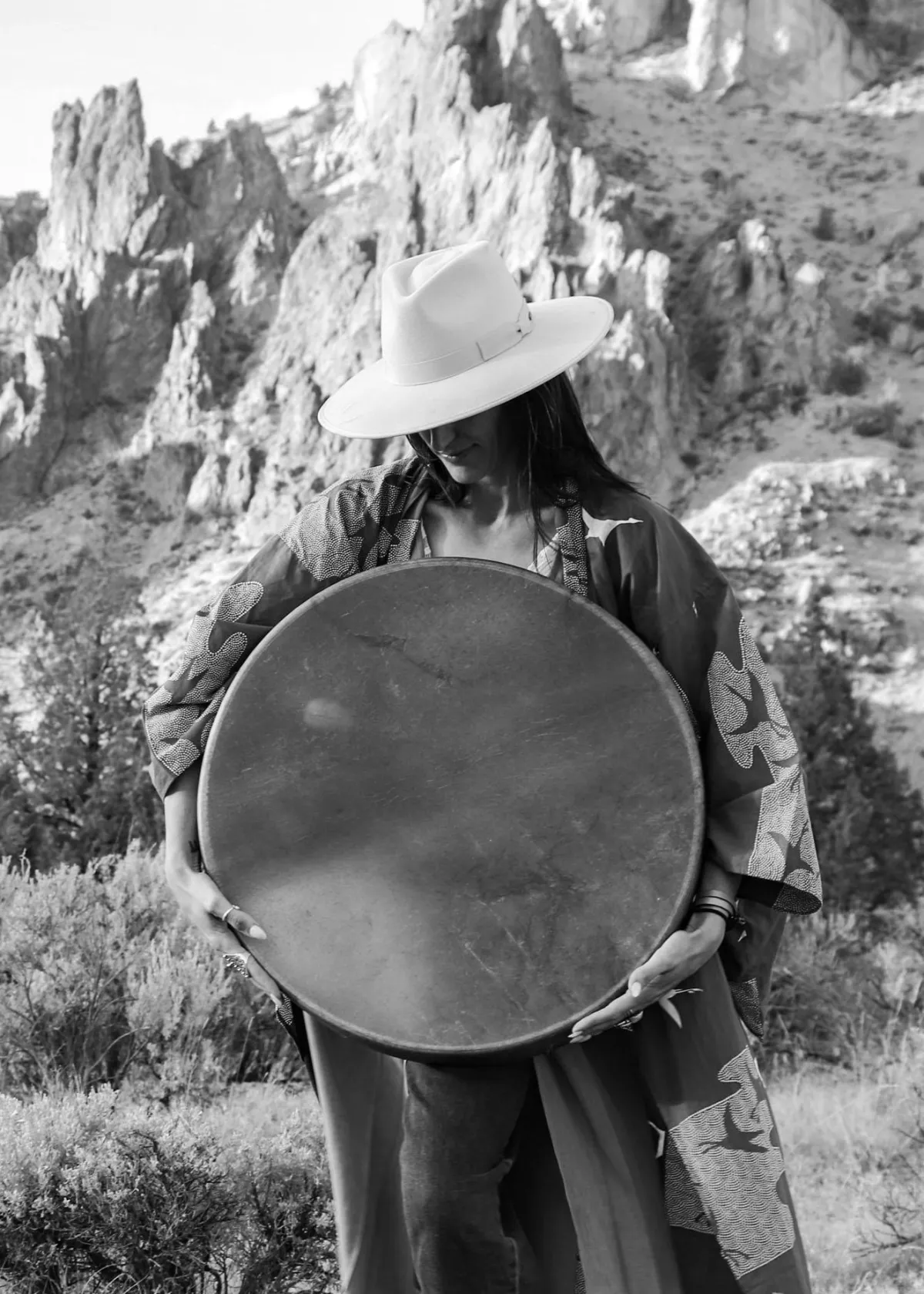 woman at smith rock playing a tibetan bowl offering sound healing to central oregon