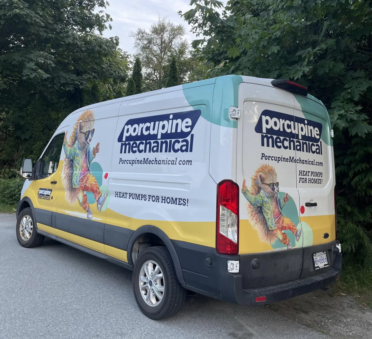 Tall apartment building with balconies under stormy sky