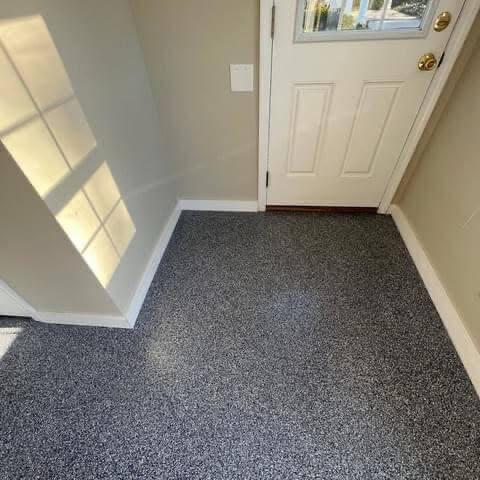 a pair of baby shoes sitting on the floor next to a bed