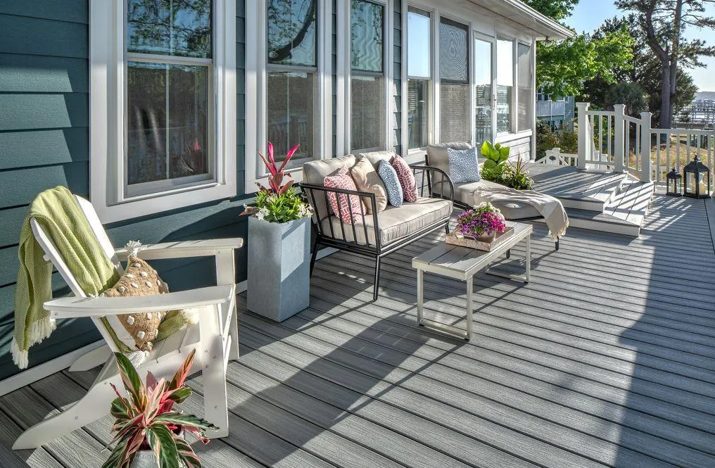 Spacious and stylish deck design featuring modern outdoor furniture with vibrant plant accents for elegant home exterior ideas.