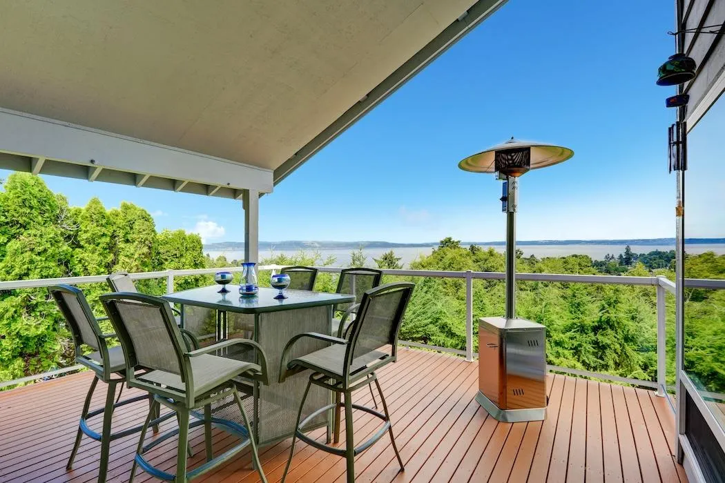 Spacious deck with modern patio furniture overlooking a serene lake view, ideal for Skyline Decks outdoor living spaces.