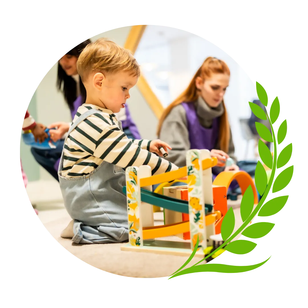 Child playing while teacher is supervising