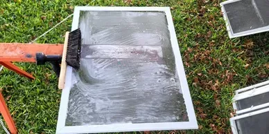 Professional window screen cleaning service by Shinetime Solutions showing dirty screens restored to like-new condition