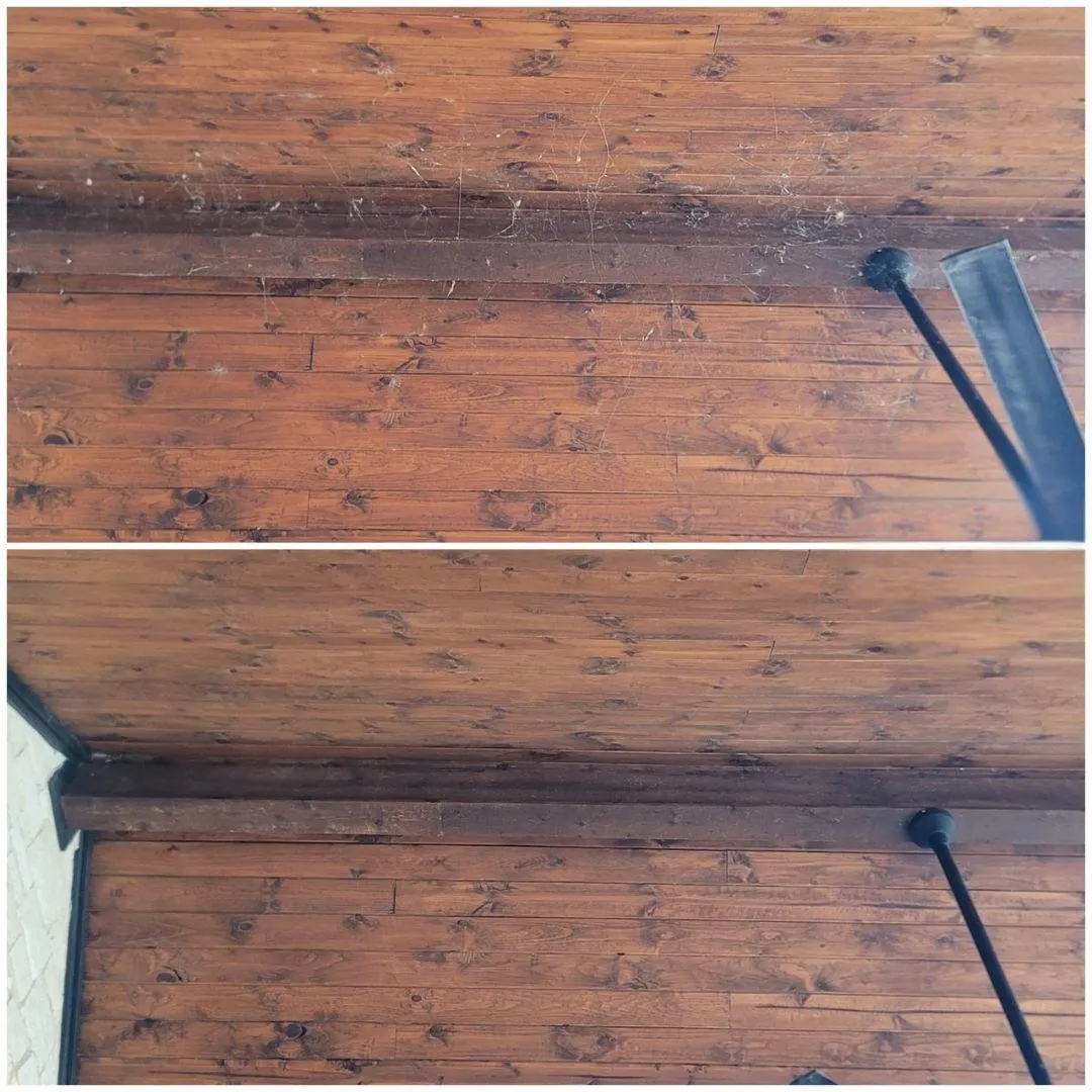 Professional overhead dust and cobweb removal by Shinetime Solutions clearing spider webs from wooden ceiling beams