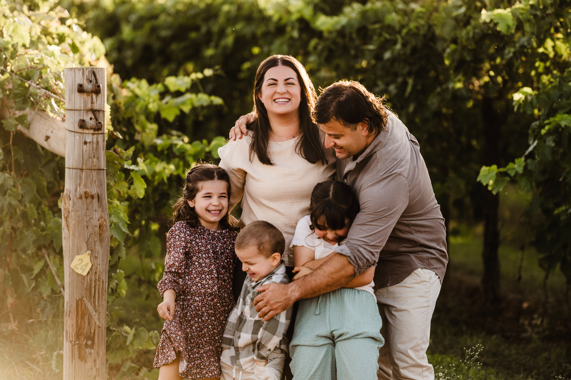 Family hugging among the vines in Mildura