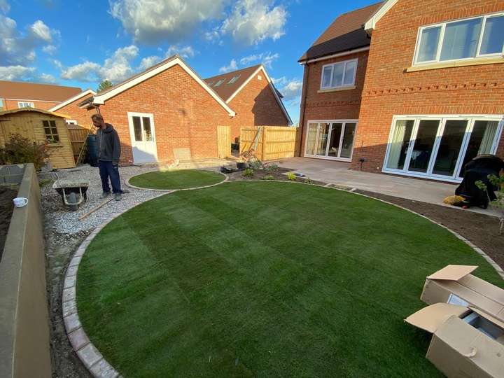 Circular turf lawn with brick edging and patio — turf laying and landscaping project in Reading