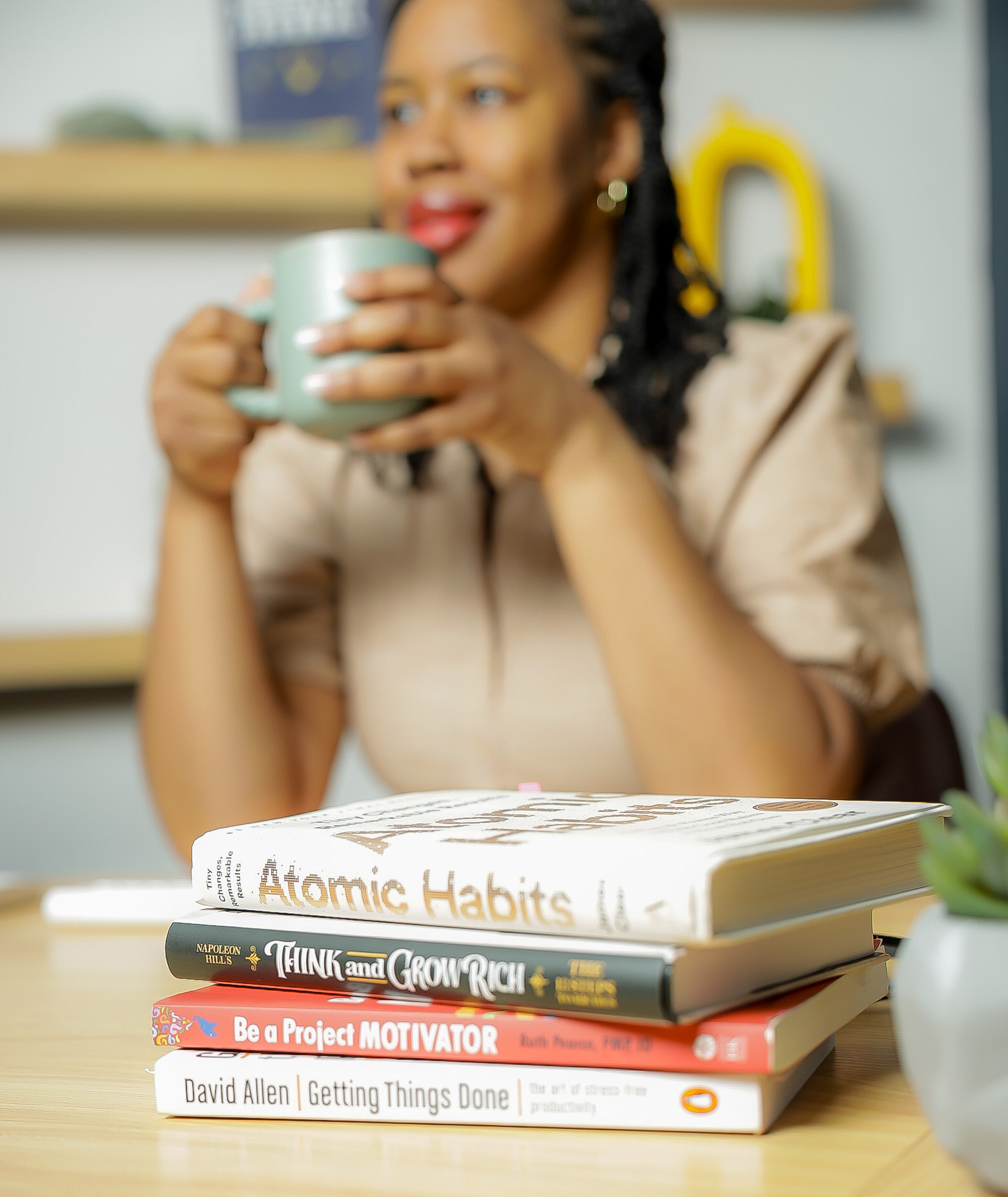 Women entrepreneurs laughing and reviewing content on a phone in a bright studio