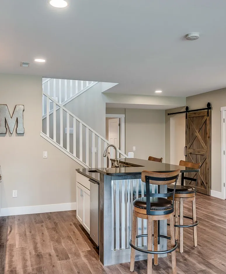Finished basement in Charlotte featuring a bright living area and recessed lighting