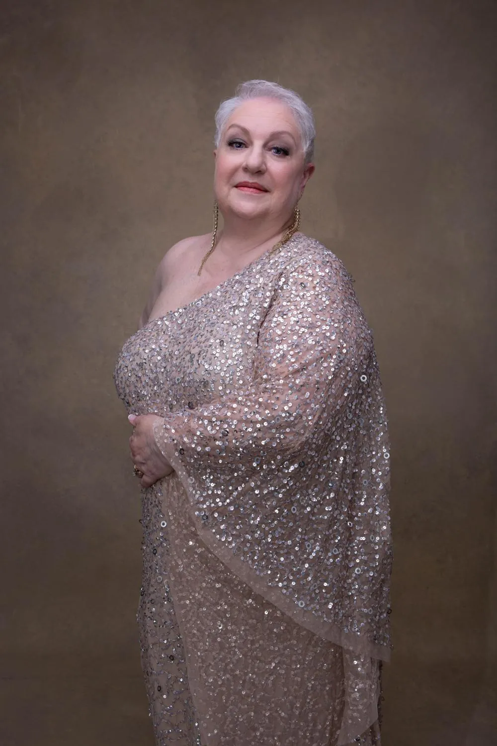 Portrait of a confident woman in her 40s in minimal studio setting