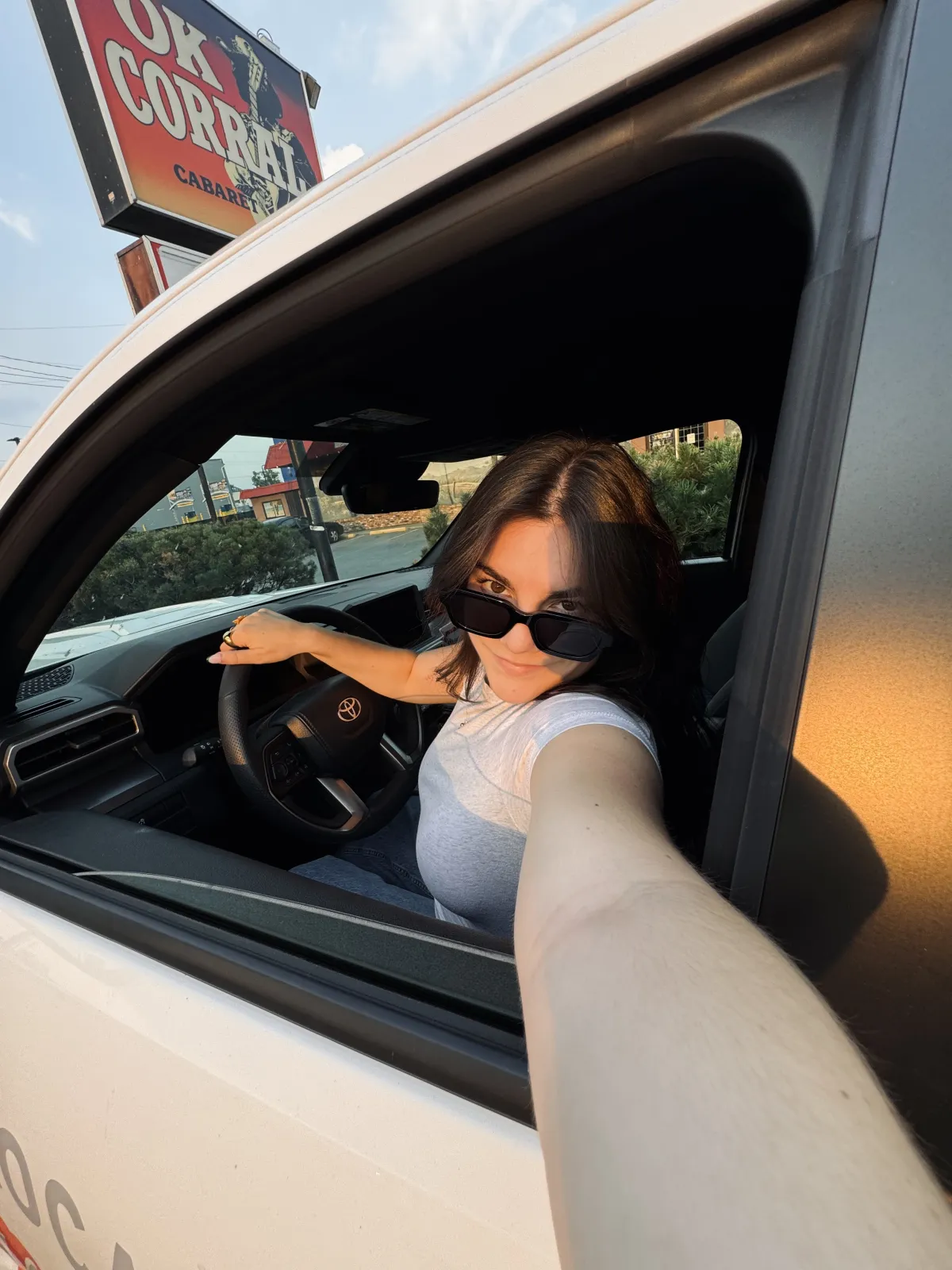 Jade Sprake taking a selfie from the driver’s seat of a Toyota truck with sunglasses on.