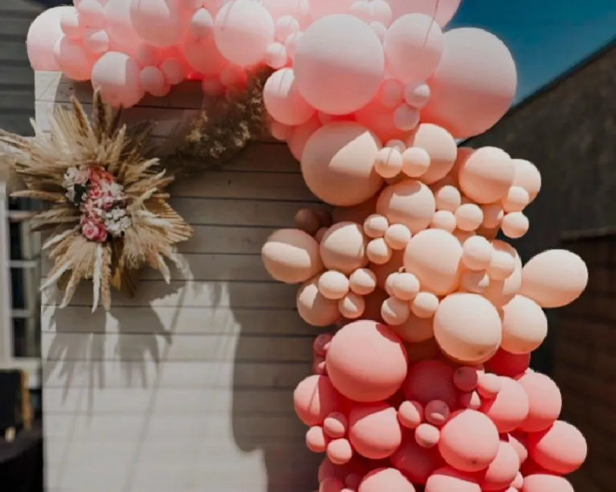 Elegant blush and cream balloon garland for a small event backdrop by Allison’s Lovely Creations.