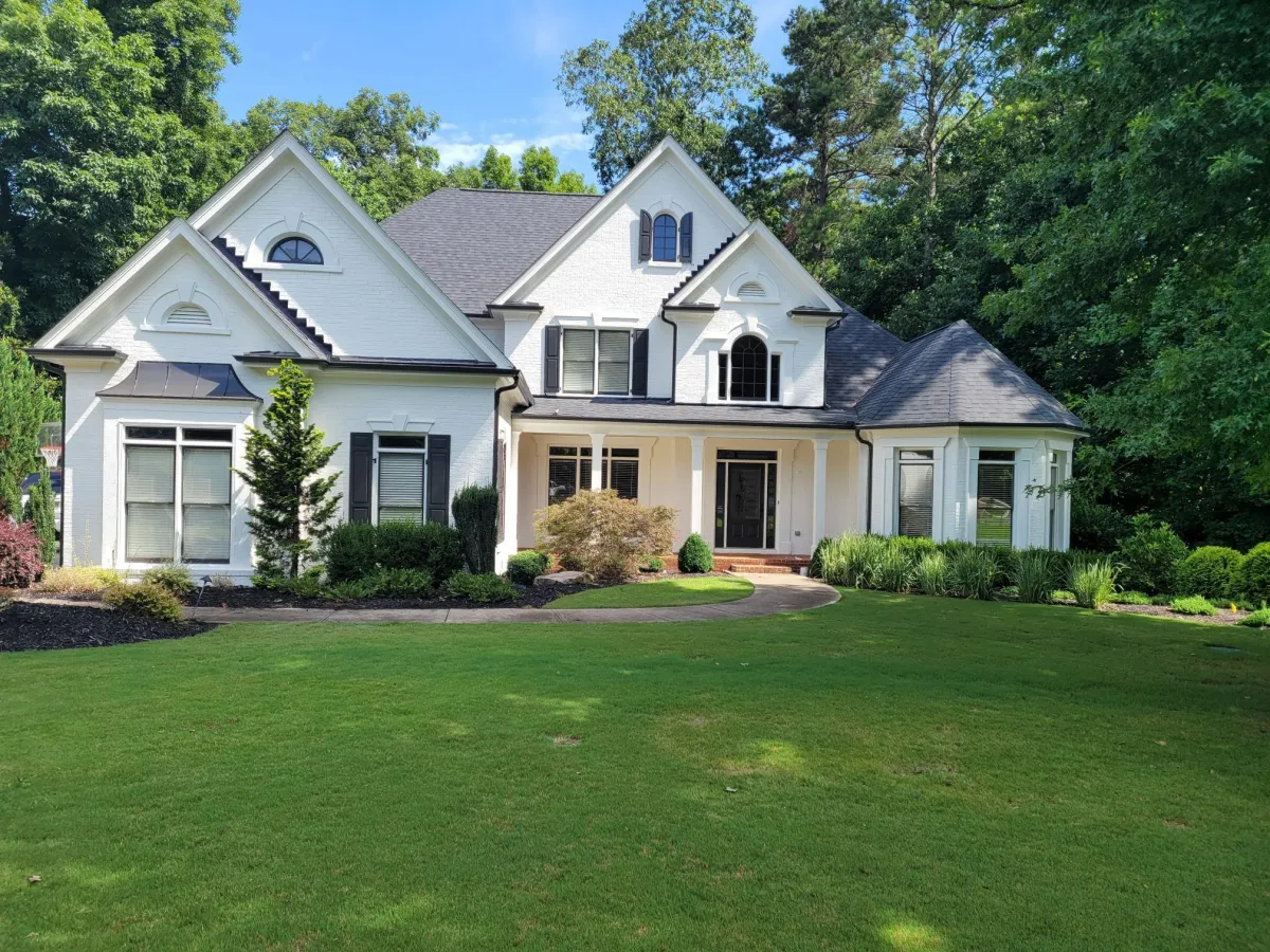 expert exterior painting on large white colonial home with black trim in Milton GA