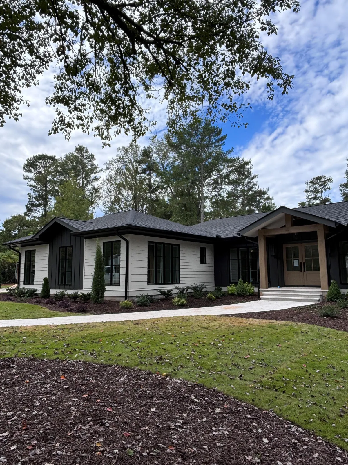 freshly painted white ranch style home with modern black roof in Canton GA
