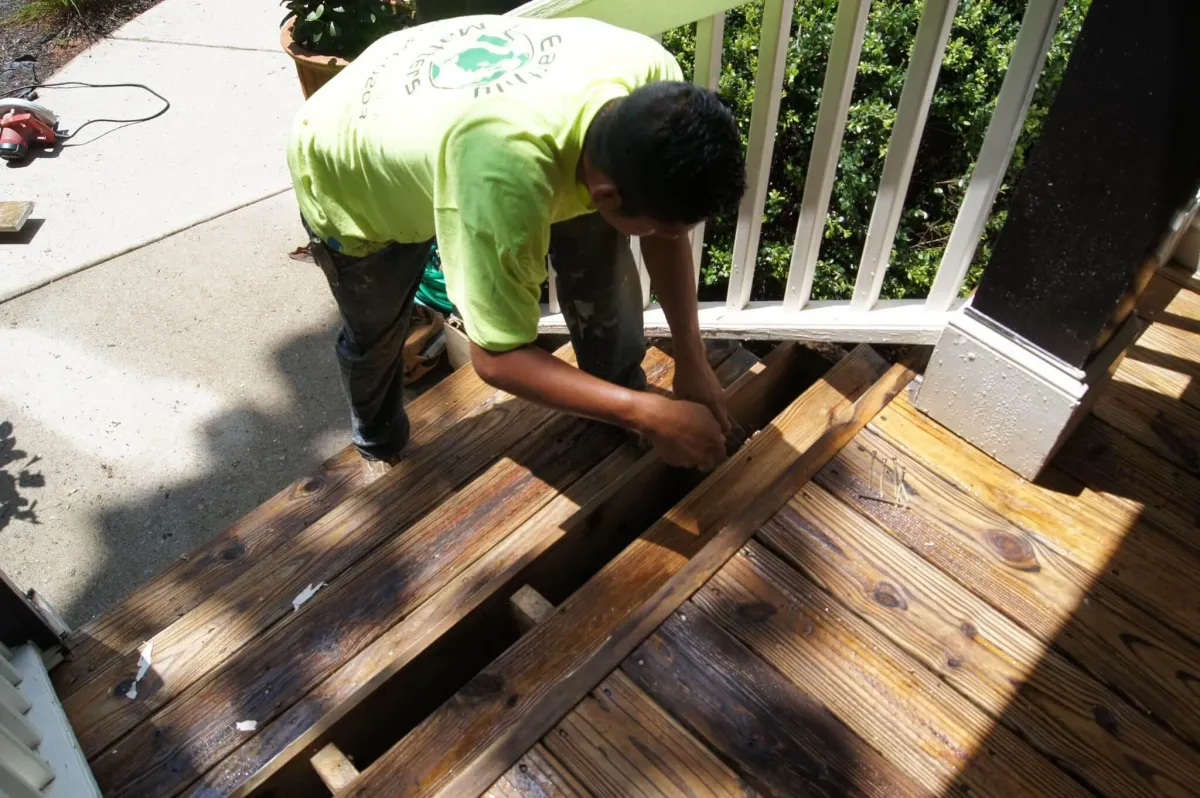 A close-up showing a professional using precision to remove a section of rotted exterior wood on a North Atlanta home.