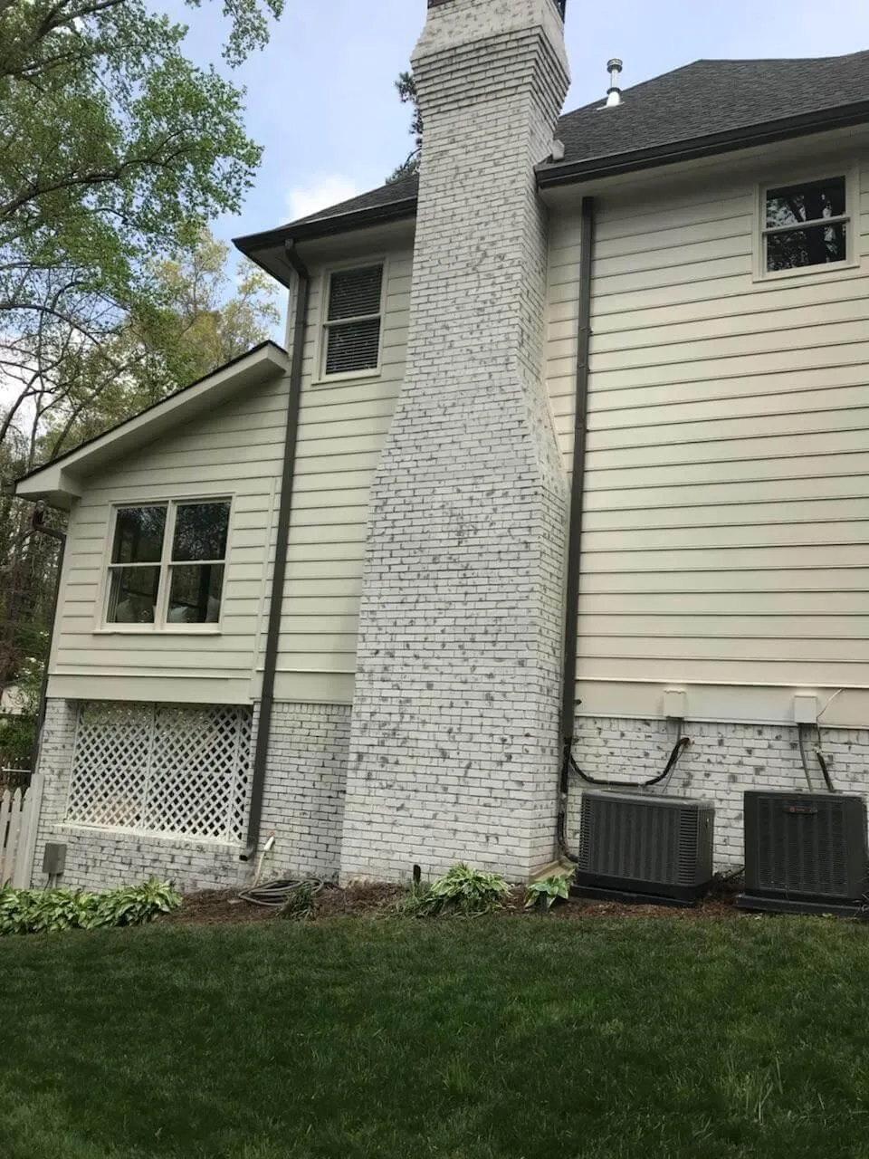 A clean and updated look featuring the same chimney, now painted a brilliant white to match the refreshed siding.