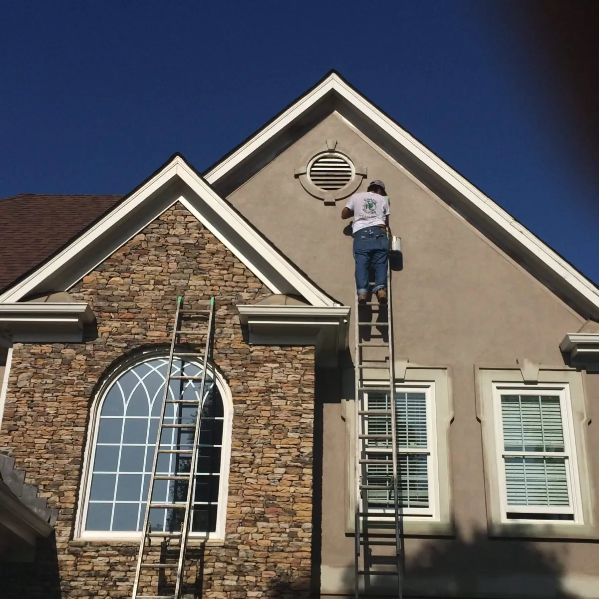 An Earthly Matters technician inspecting and probing rotted siding in Alpharetta to assess the extent of the damage.