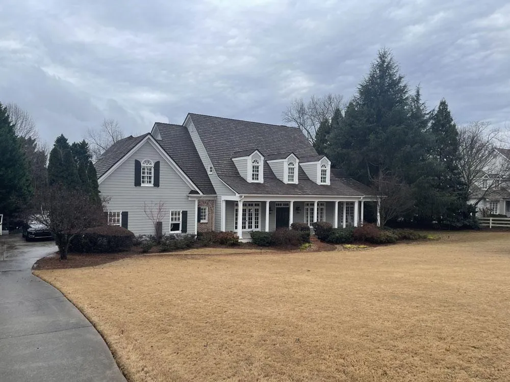 Elegant estate home unified with a soft, light gray exterior paint color, creating a clean and sophisticated look