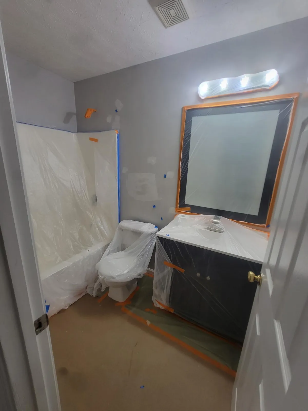 A professional application of drywall tape during a seamless wall repair in a North Atlanta home.