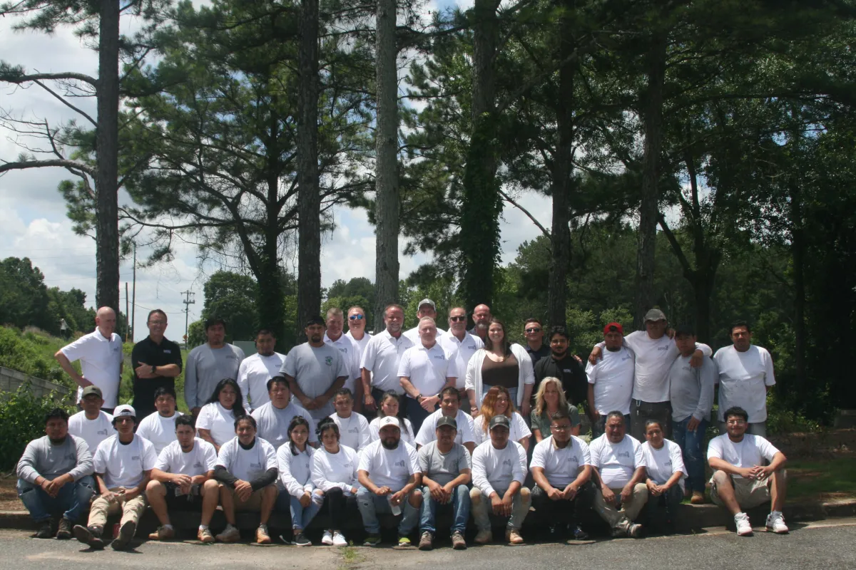 The entire Earthly Matters Painting crew, a large and professional team of men and women, posing for a group photo outdoors in North Atlanta.