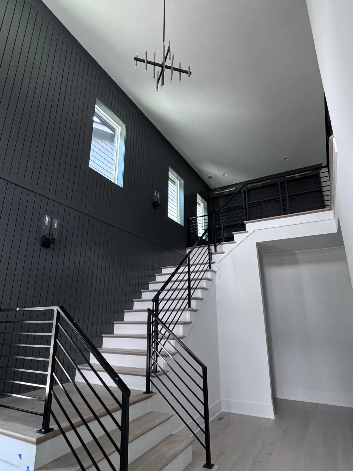 modern interior painting with dark accent wall and white trim in Alpharetta GA