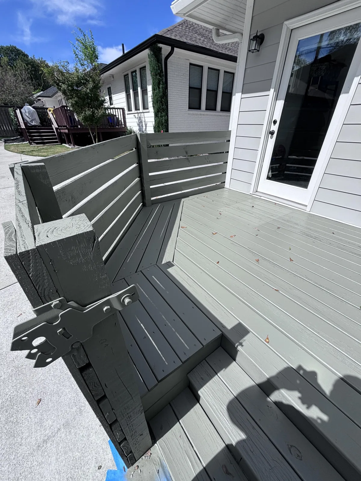 expert gray solid deck stain application on multi-level backyard deck in Milton GA