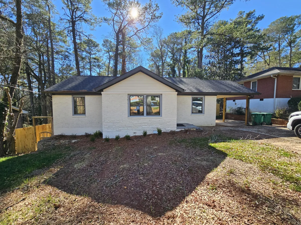 painted white brick ranch home exterior with modern dark window trim in Canton GA