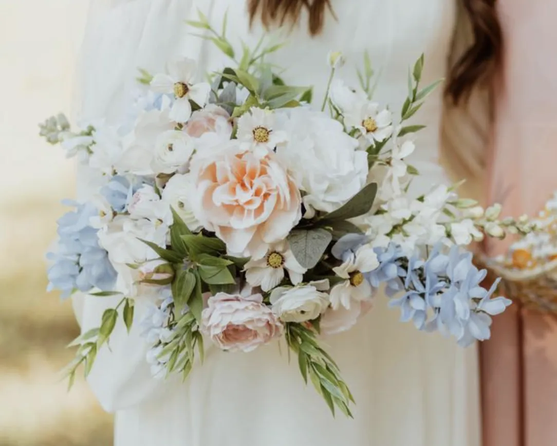 woman holding bouquet of flowers