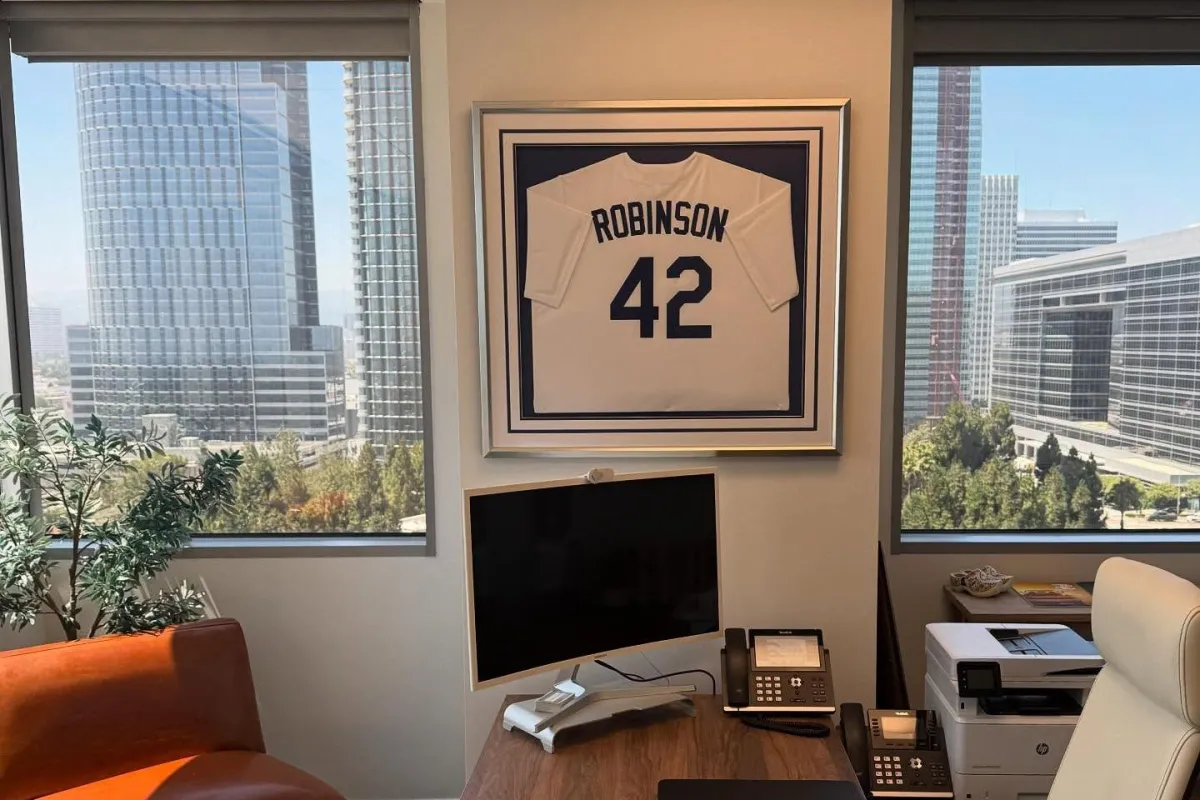 Custom framed sports jersey displayed in a professional office interior